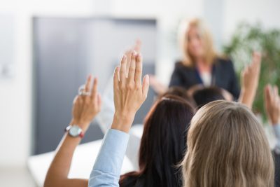 Group of women voting during seminar